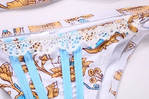 Détail du bikini floral baroque avec bretelles plissées bleues et dentelle blanche