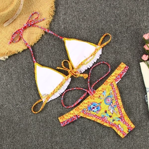 Flat lay detail of bohemian printed bikini with ruffle trim and string side ties