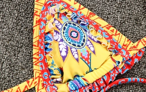 Close-up of bohemian bikini with ruffle edges and mix of geometric and leopard prints