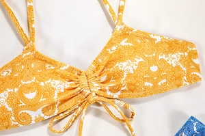 Macro detail of yellow baroque floral print bikini top with adjustable drawstring front