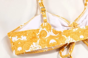 Detail of yellow floral bikini top with adjustable straps and metallic buckles