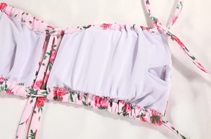 Detail of pink floral bikini top showing inner lining and removable pad pocket design
