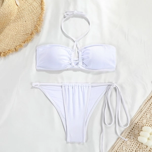 Detailed macro view of white bikini top with ruched center and textured fabric detail