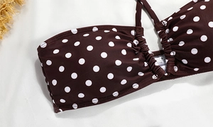 Detail view of brown polka dot bikini top with shirred fabric and S size laundry label