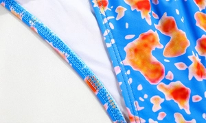 Close-up of blue floral bikini fabric showing high-quality double-needle stitching detail