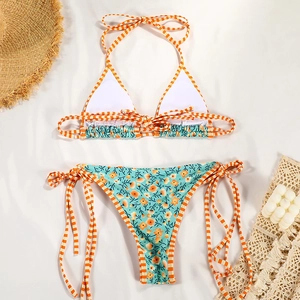 Detail of floral two-piece bikini with contrast gingham ties and vibrant summer pattern