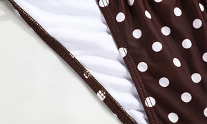 Detail of brown polka dot bikini fabric with white lining and neat stitching