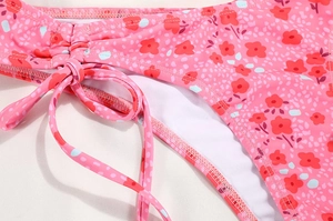 Detail of pink floral bikini with side tie strings and high-quality stitching texture