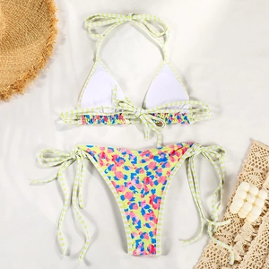 Flat lay of a vibrant two-piece bikini with floral leopard print and striped ties