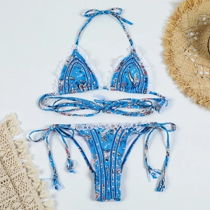 Close-up of bohemian print bikini with white lace trim and adjustable tie-up details