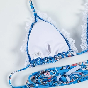 Detail view of floral bikini top with white lace trim and M size material label