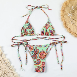 Close-up of mint green paisley bikini with metallic ring detail and side-tie strings