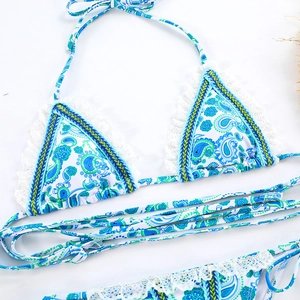 Detailed close-up of paisley print bikini top with lace trim and woven edges