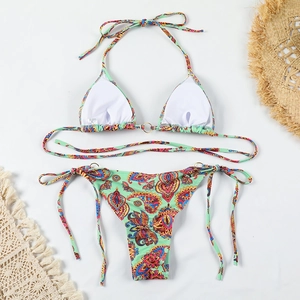 Detailed flat lay of bohemian paisley bikini with mint green base and metallic ring accents