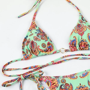 Close-up of mint paisley bikini with golden ring detail and adjustable side ties