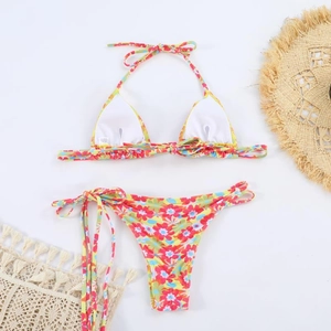 Floral print halter bikini set with side-tie bottoms and resort style accessories