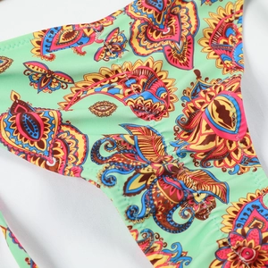 Detail of mint green paisley print bikini fabric with high quality stitching and texture