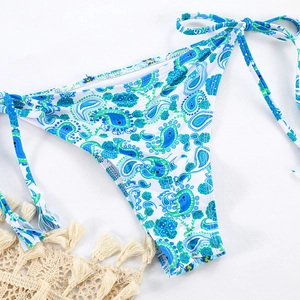 Detail of paisley print bikini bottom with side-tie straps on a clean white surface