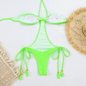 Detail of neon green monokini with drawstring ties, gold beads and fringe accents