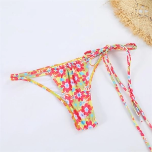 Detailed macro view of colorful floral bikini bottoms with adjustable side tie strings
