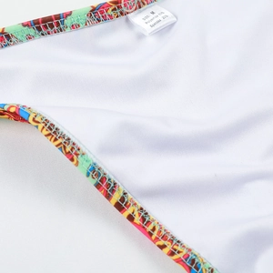 Detail of swimsuit fabric tag showing 80% polyamide and 20% spandex material composition