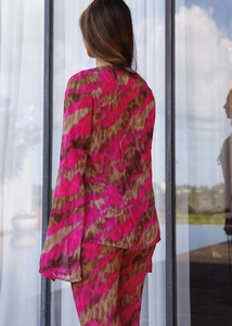 Back view of a long sleeve chiffon set with vibrant pink and brown Ikat abstract patterns