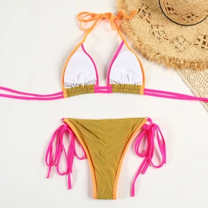 Flat lay of a two-piece bikini with metallic gold waist and vibrant contrast ties