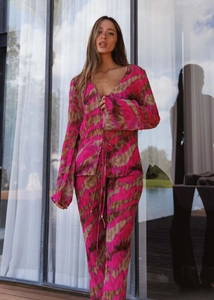 Close-up of a vibrant pink and brown animal print two-piece chiffon set with flared sleeves