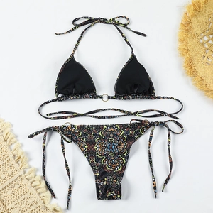 Detail view of a boho print bikini with golden ring connectors and side tie bottoms