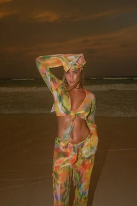 Detail of colorful tie-dye chiffon beach set with tie-front crop top and trousers