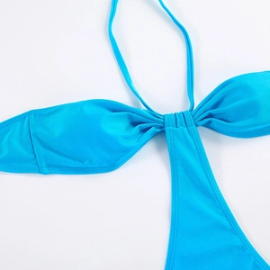 Detailed view of bright blue one-piece swimsuit featuring halter straps and ruched bust design