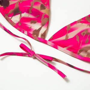 Detail of bright pink and brown floral bikini top with delicate tie-up bow closure