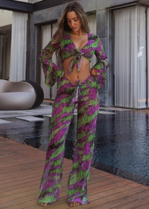 Detail of a two-piece tie-dye set with long sleeve crop top and wide leg pants in marble print
