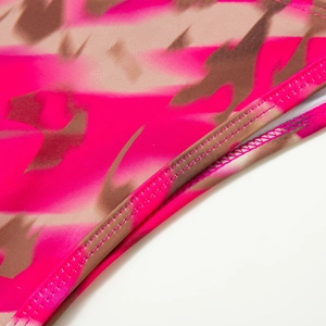 Detailed macro view of high-quality double-stitch sewing on printed bikini fabric