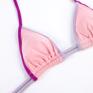 Detail of pink and purple triangle bikini top showing high-quality stitching and fabric texture