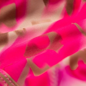 Close-up of pink and brown floral print swimsuit fabric with breathable mesh texture