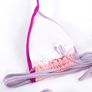 Detail of bikini top inner lining with M size tag and 80% Polyamide fabric material