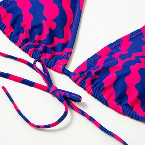 Detail of pink and navy striped bikini top showing high-quality stitching and fabric texture