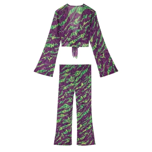 Detail of chiffon two-piece set featuring purple and green zebra print and tie-up front
