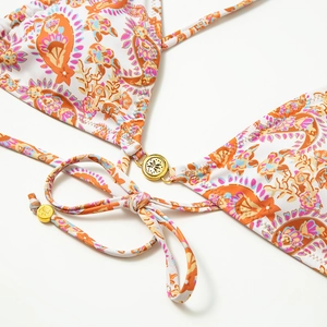 Close-up of paisley floral bikini with gold palm tree ring detail and adjustable straps
