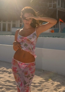 Detail of floral mesh three-piece beach set with lace edges and pink ribbon bows