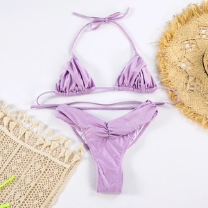 Detail of lavender shimmer bikini set featuring ruched fabric and pearlescent texture