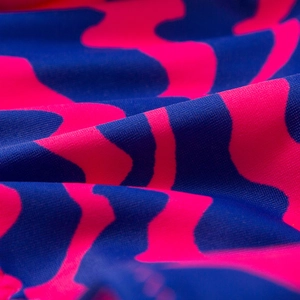 Detailed close-up of pink and royal blue wavy striped knit bikini fabric texture