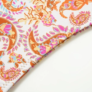 Close-up of paisley print fabric with high-quality zigzag stitching and vibrant textures