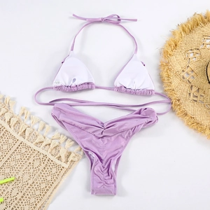 Detail of light purple pleated bikini with strappy top and matching V-shaped bottoms