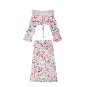 Close-up of floral chiffon off-shoulder crop top and ruffled skirt with pink flower print