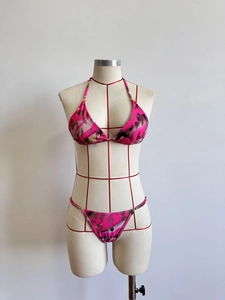 Detail of pink camouflage bikini set featuring halter neck and gold ring hardware