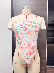 Detailed view of the colorful floral chiffon scarf wrapped as a tube top on a mannequin