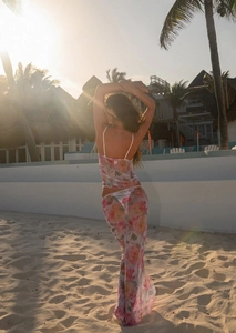 Close-up of floral mesh two-piece beach set with bow lace detailing in sunset beach setting