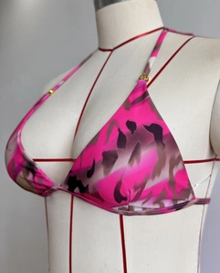 Detail of pink camouflage bikini top featuring classic triangle cups and gold metal ring